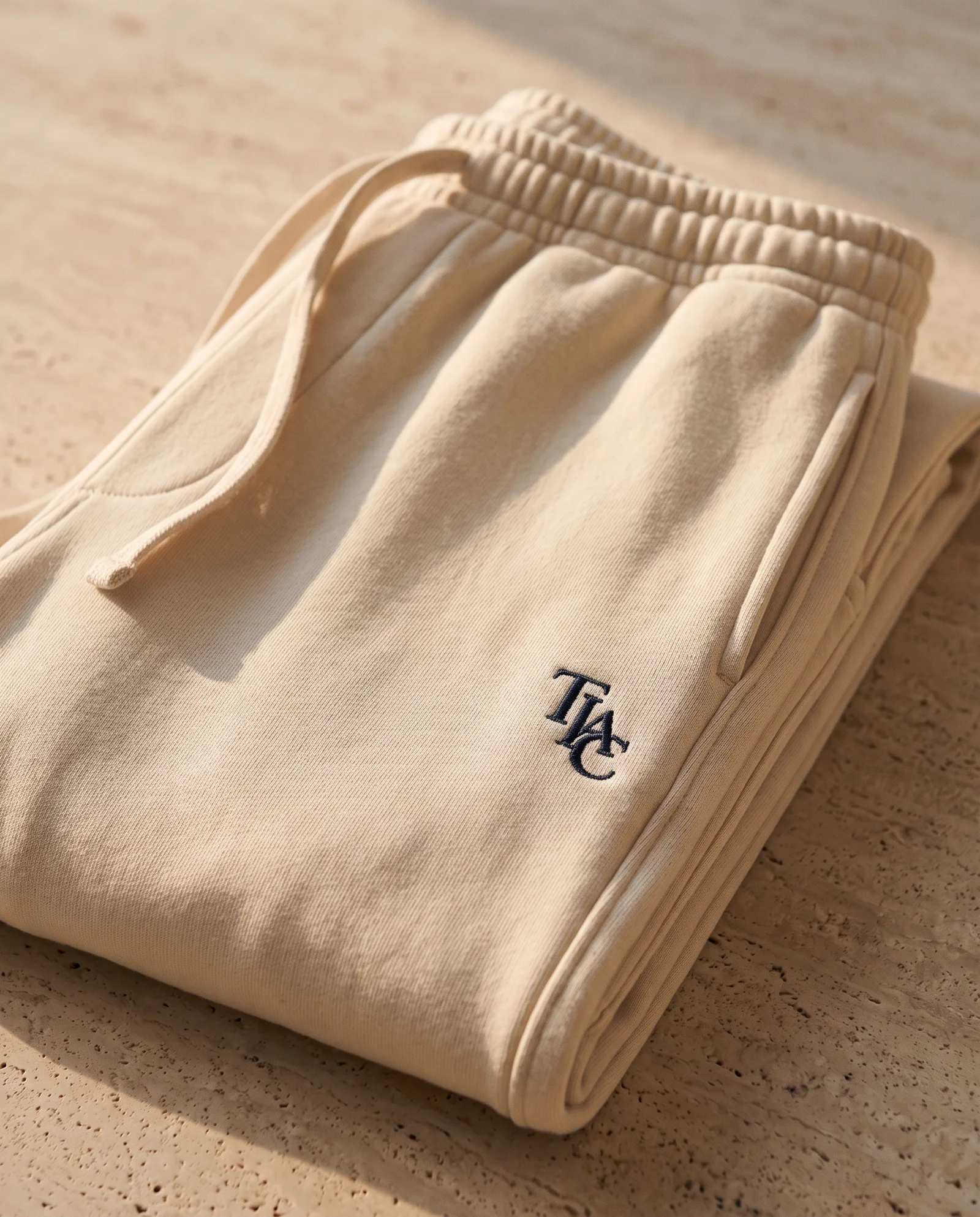 TIAC sweatpant waistband, fleece and monogram detail